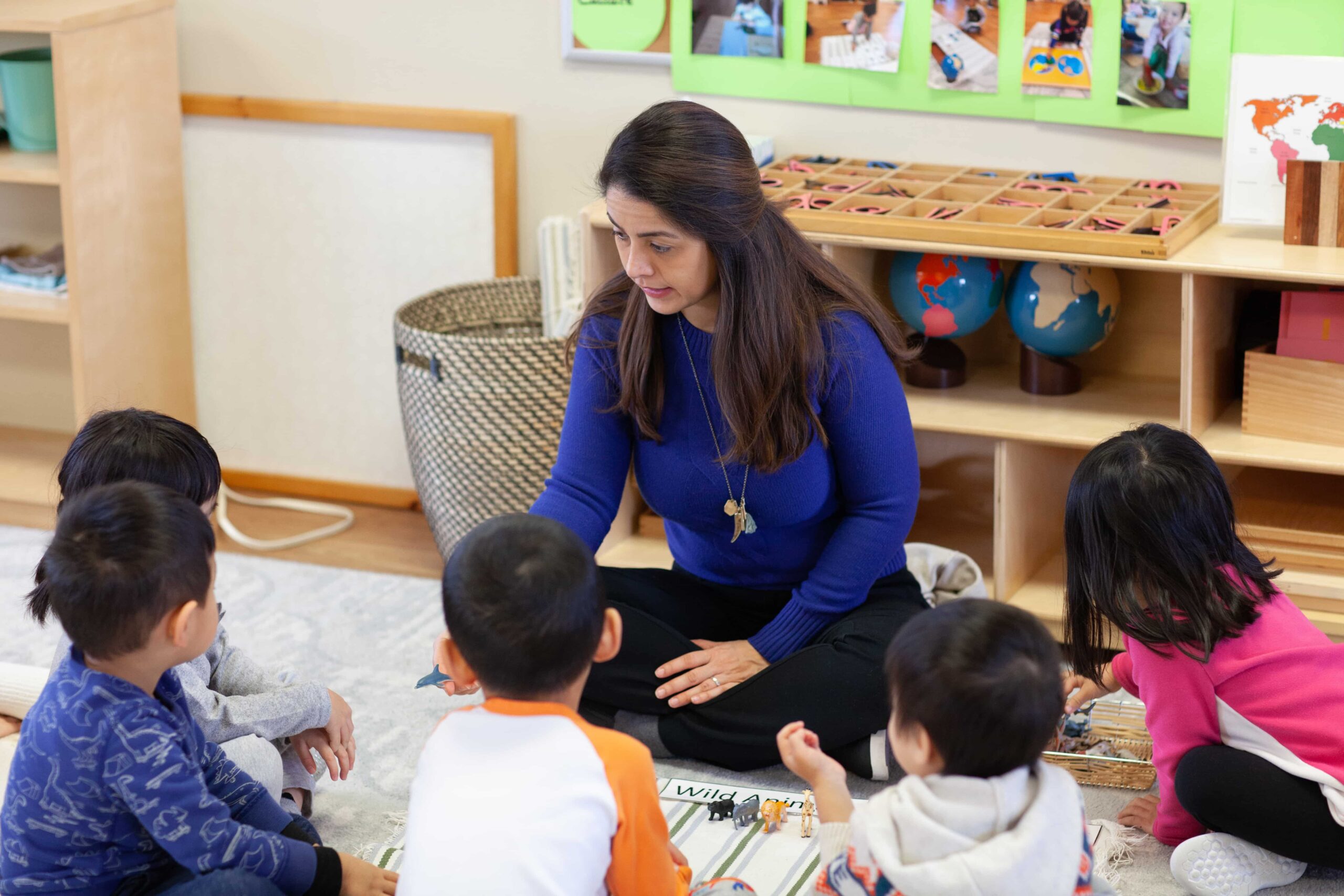 Certificated teacher supporting children in an early learning classroom