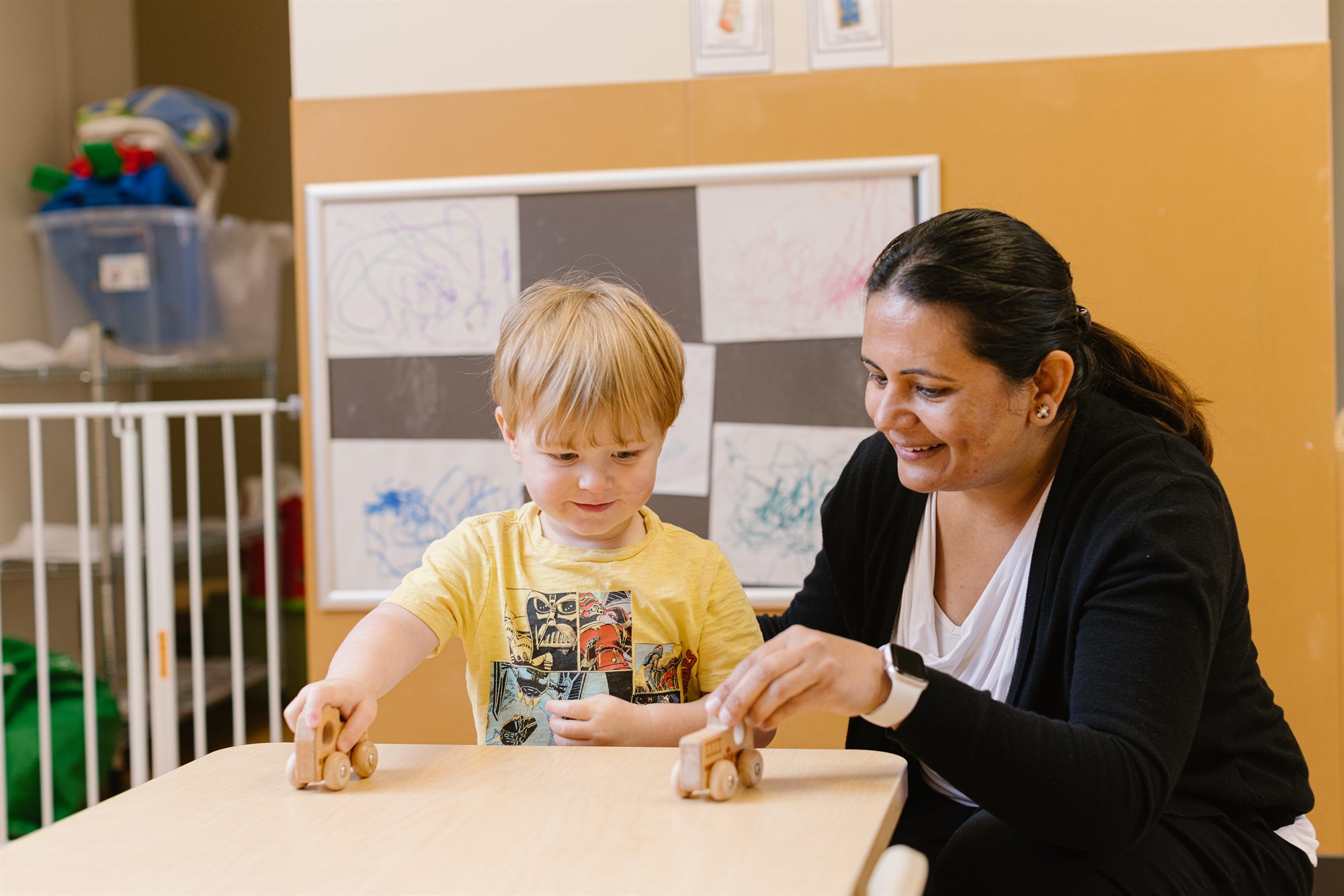 Occupational therapist supporting a child with fine motor development
