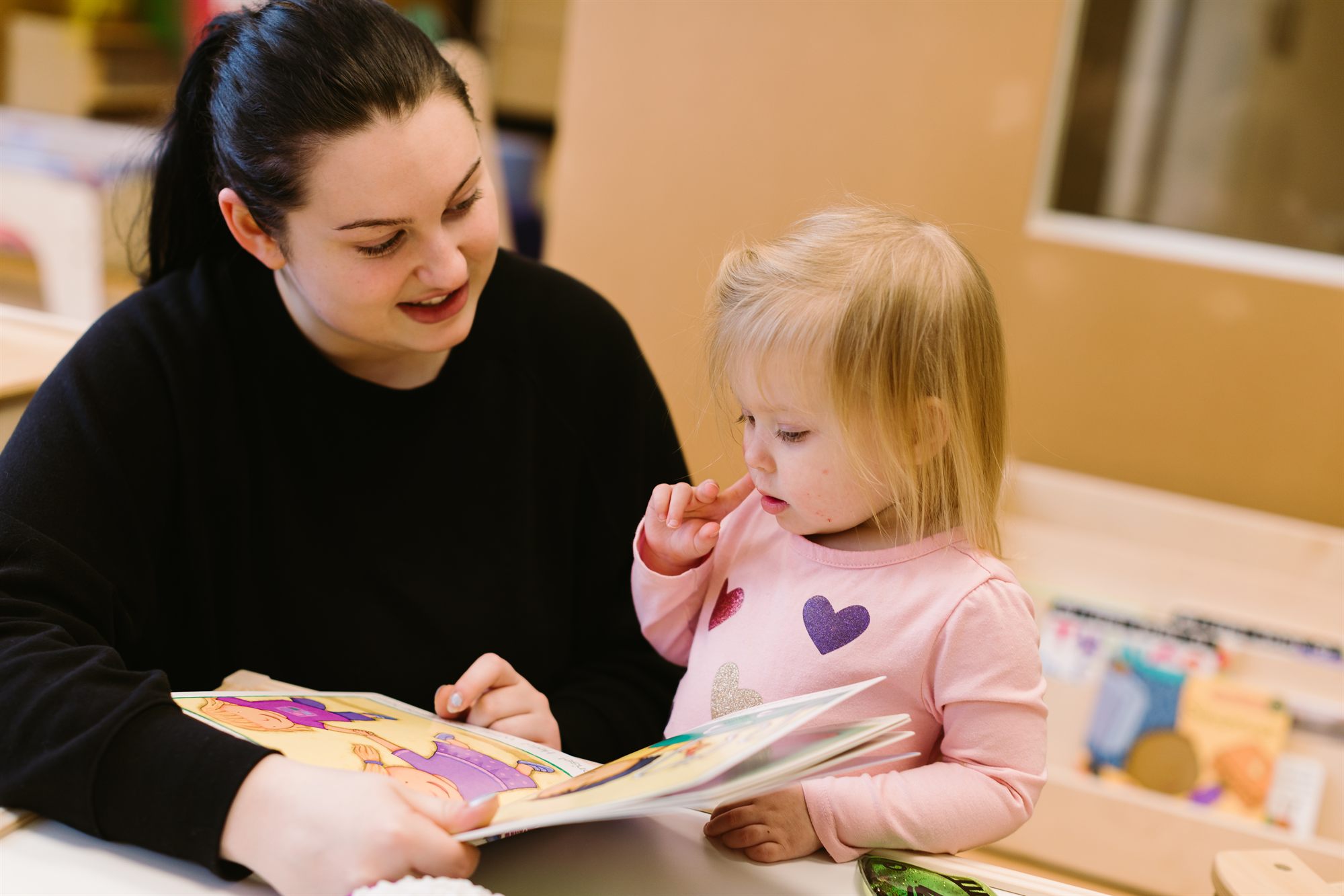 Speech and language specialist engaging a child in a communication activity